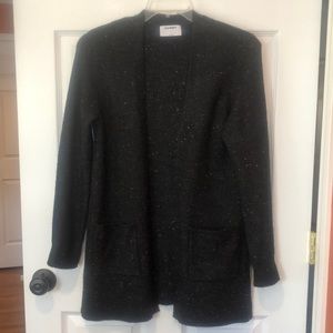 Great cardigan black with small flecks of turquoise, peach, apricot.
